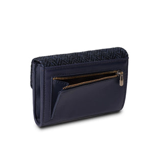 Rear view of a Harris Tweed navy blue herringbone purse, featuring a zipped compartment at the back. The compact size and golden zipper closure make this purse practical and stylish, while the 100% genuine Harris Tweed fabric ensures durability and quality. The fabric is handwoven in the Outer Hebrides of Scotland, making each purse unique.