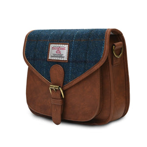 Side view of the Islander Navy Over-Check Harris Tweed Saddle Bag showing the depth of the bag. The shoulder strap has been removed.