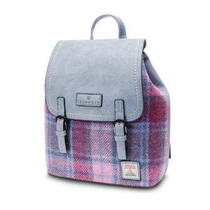 Side view of the pink tartan and blue Harris Tweed backpack showing the width of the medium size.