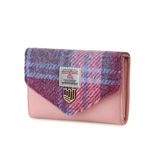 Side view of a pink and blue tartan Harris Tweed ladies wallet with a snap closure. The wallet has multiple card slots and a coin pouch for organisation.