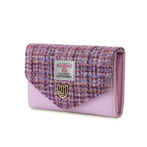 An image of a violet dogtooth Harris tweed purse viewed from the side. The classic dogtooth pattern is visible on the front. The rich violet hue adds a touch of sophistication to the design.