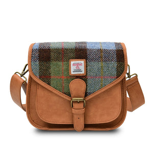 Chesnut (Brown) and Blue Tartan Harris Tweed Saddle Bag. The bag has a unique tartan pattern in warm brown and cool blue hues with a spacious interior and an adjustable strap for comfortable carrying.