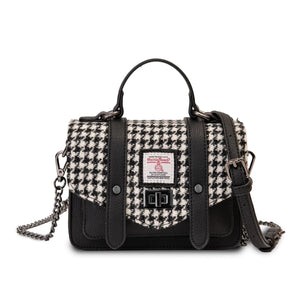 Harris Tweed handbag with a black synthetic leather body and black and white dogtooth design. The bag has a removable chain shoulder strap drapped across the top.