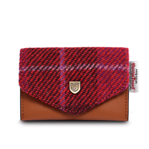 Card holder purse made from blue synthetic leather and Fuschia, red and pink, tartan Harris Tweed. The Harris Tweed authenticity label can be seen on the right hand side of the purse