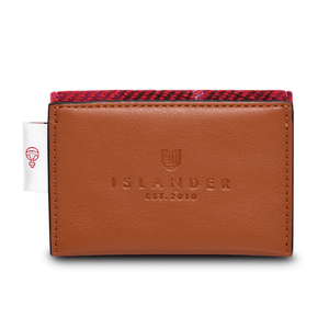 Back of the card holder showing the brown synthetic leather stamped with the Islander logo. On the left hand side is the authenticity label from Harris Tweed.