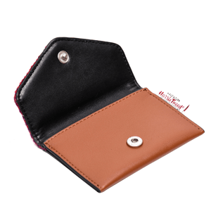 Inside the card holder showing the brown synthetic leather and internal black colouring. There is a clasp closure. 