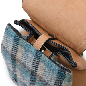 The Islander Harris Tweed Jura Backpack with the top open showing the internal clasp closer. 