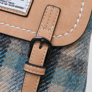 Close-up of the cream, blue and turquoise tartan of the Islander Harris Tweed Jura Backpack including one of the buckles.