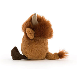 Side view of the Jellycat Amuseabean Highland Cow Children’s Soft toy with his dinky cordy legs stretched out in front. 