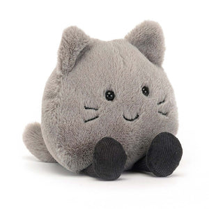 An image of the Jellycat Amuseabean Kitty plush toy, a soft and round pebble-shaped feline with stitch whiskers, grey-blue paws, a perky tail, and alert ears.