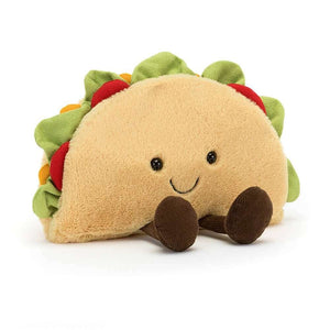 The Jellycat Amuseable Taco is a children's soft toy in the shape of a Mexican taco with lettuce and tomato filling. 