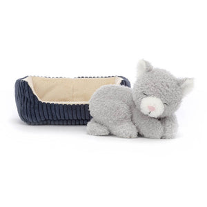 Jellycat Napping Nipper Cat is an adorable soft toy kitten with soft and cloudy pebble grey fur, cream-splash snoot, and perky ears cuddled up in a cosy cordy blue bed with beautiful buttercream lining.