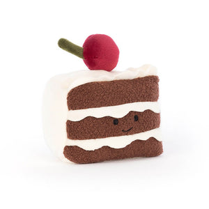 Image of Pretty Patisserie Gateaux cake plush soft toy from Jellycat, with three layers of fluffy sponge cake, cream icing ruffles, and a cherry on top in scarlet and green.