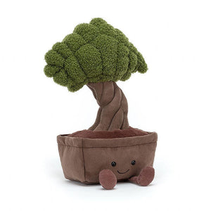 Jellycat Bonsai Tree children’s soft toy. They pot has a big smile and round eyes and little corduroy feet protruding from the front. The tree is made up from a twisted stem and soft fluffy green leaves. 