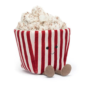 Jellycat AMuseable Popcorn children’s soft toy comes in a red and white striped container with soft popcorn on the top. It has a smily face and little brown corded legs sitting out in front. 