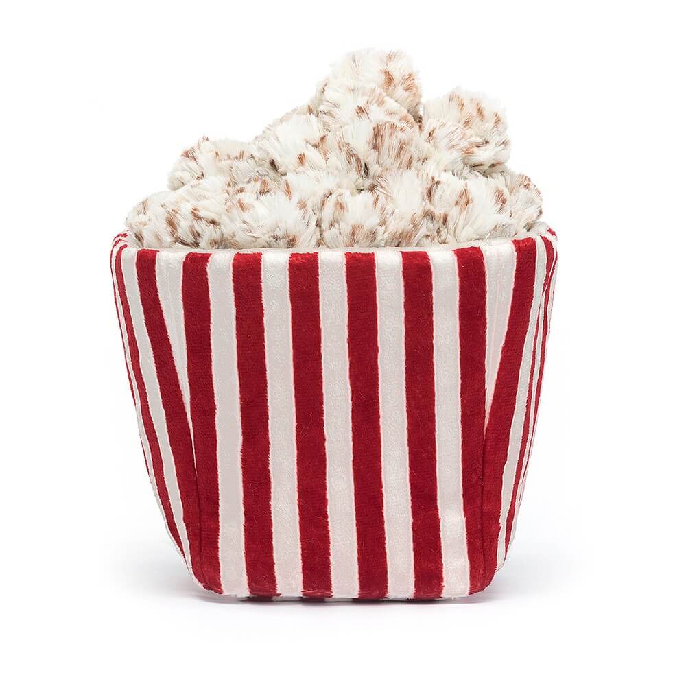 From behind the Jellycat Amuseable Popcorn children’s soft toy. 