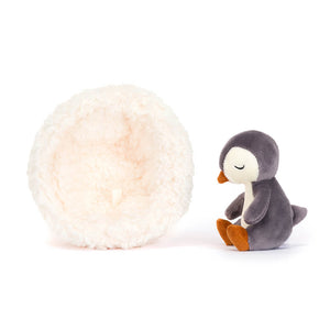 Jellycat Hibernating Penguin with the nest on the left and children’s soft toy on the right. 