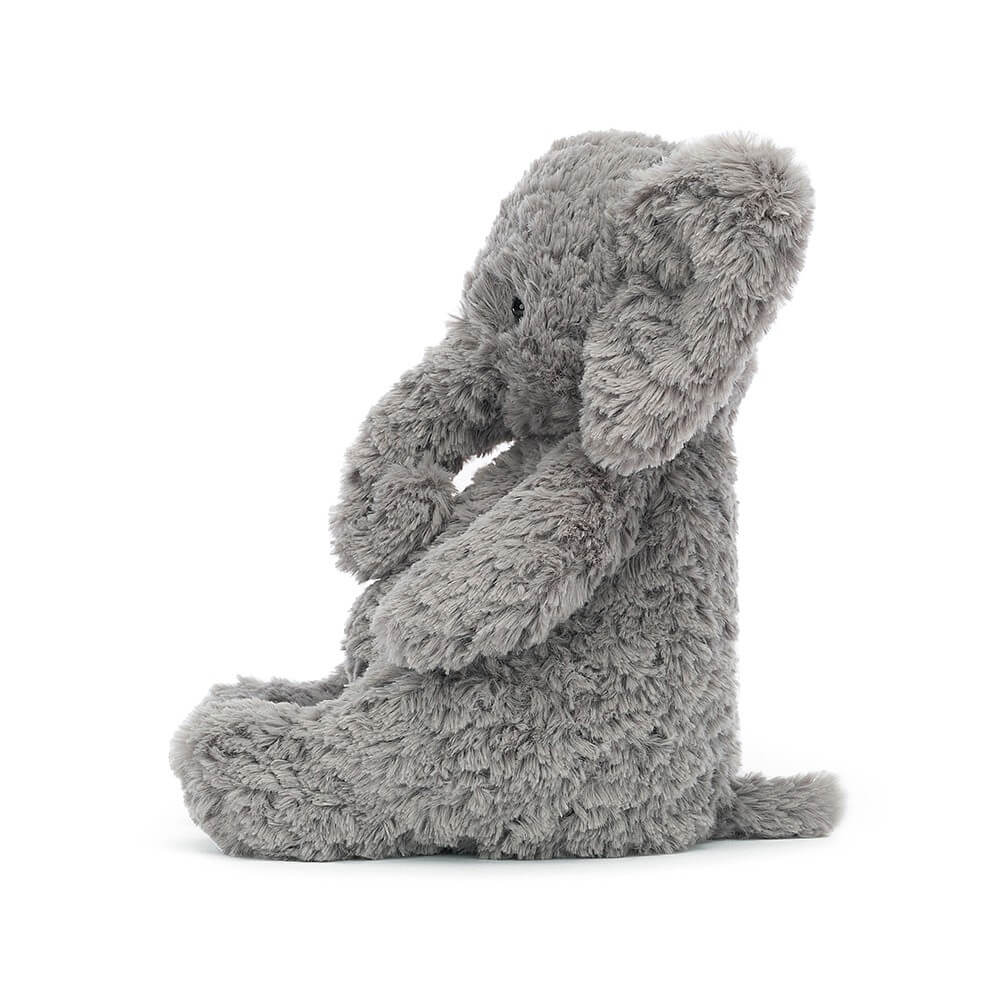 From the side Jellycat Archibald Elephant children’s soft toy with legs stretched out in front. 
