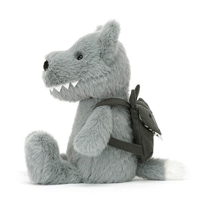 From the side Jellycat Backpack Wolf children’s soft toy with legs sticking out in front. 