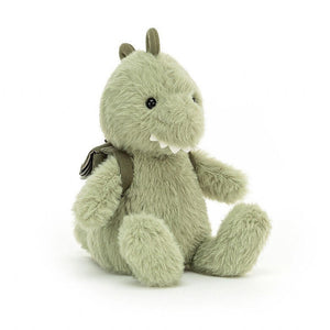 Jellycat Backpackers Dino Dinosaur themed children’s soft toy covered in green soft fur and wearing a mini backpack on his back. 