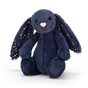Jellycat Bashful Bunny covered in navy blue fur with little silver stars shimmering on the insides of its ears. 