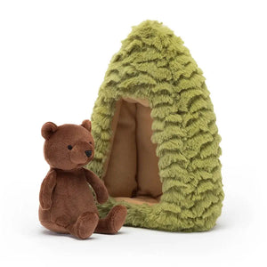 Jellycat Forest Fauna Bear children’s soft toy. This is a little brown bear sitting outside its home which is a green tree. 