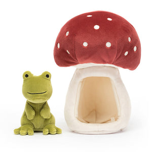 Jellycat Forest Fauna Frog children’s soft toy. The green frog sits on the left and the red spotted mushroom home sits on the right. 