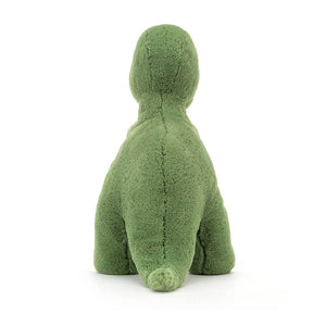 From behind the Jellycat Fossilly T-Rex dinosaur children’s soft toy with tail stretched out behind him. 
