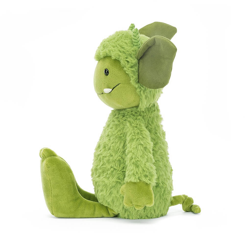 From the side Jellycat Grizzo Gremlin with his feet stretched out in front. 