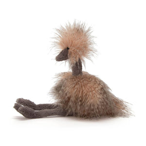 From the side Jellycat Odette Ostrich with her legs stretched out in front and covered in silky pink feathers.