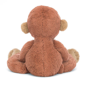 Jellycat orangutan children’s soft toy from behind showing his dark drown fur and light brown ears.