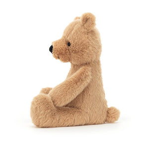 Side angle of the Jellycat Rufus Teddy Bear. He is covered in soft brown fur and has his legs stretched out in front of him.