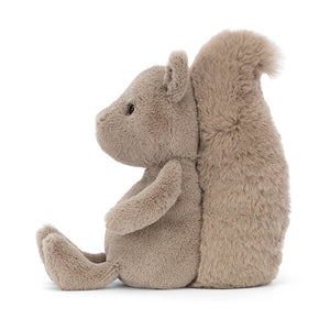From the side, Jellycat Willow Squirrel sits on its beany bottom with legs out in front. Covered in soft grey fur with a bushy tail behind. 