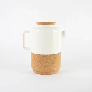 Ceramic teapot in white / cream with a cork base and lid.