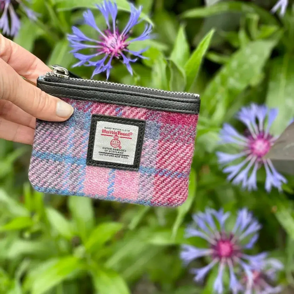 Lady holding one of the Maccessori Harris Tweed Coin Purses in Pink and blue tartan.