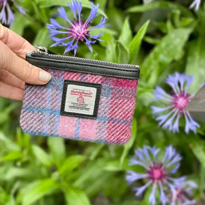 Lady holding one of the Maccessori Harris Tweed Coin Purses in Pink and blue tartan.