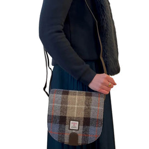 Lady wearing one of the brown and blue Maccessori Harris Tweed Crossbody Bags over her shoulder. 