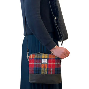 Lady wearing one of the Maccessori Harris Tweed Shoulder Bags I with a Red, Orange and Blue Tartan design. 