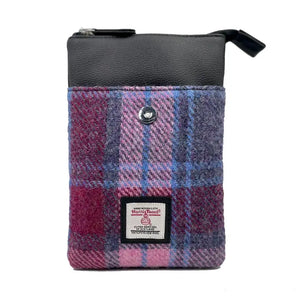 The outside pocket of the blue and pink tartan Harris tweed crossbody bag showing the fastener. 