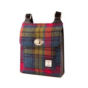 Harris Tweed satchel bag in a red, blue and green check tartan design. The shoulder straps are draped across the back.