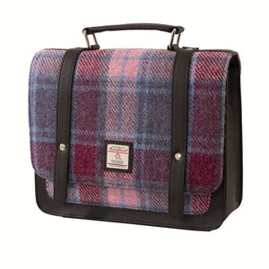 Harris tweed mini satchel shoulder bag in a pink, purple and red tartan. Shown with the top handle and leather fasteners. 