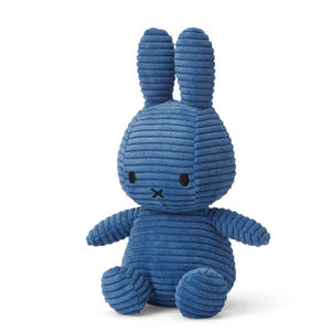 From the side sitting Miffy Bunny Rabbit children’s soft toy covered in cobalt blue corduroy fabric. 