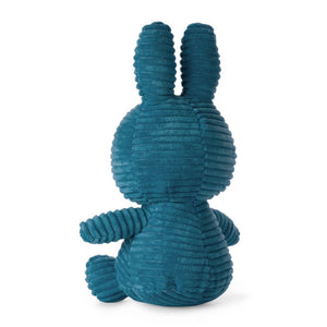 From behind Miffy sitting bunny rabbit soft toy coverd in aviator blue fabric.