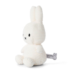 From the side the Miffy Bunny Sitting Corduroy White children’s plush soft toy. 
