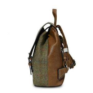 From the side the Jura Harris Tweed Backpack showing the chestnut herringbone pattern and brown synthetic leather body.